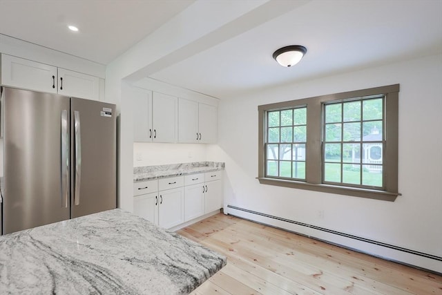 649 S Main St, Raynham, MA 02767 - kitchen featuring freestanding refrigerator, a baseboard heating unit, light stone countertops, and white cabinets