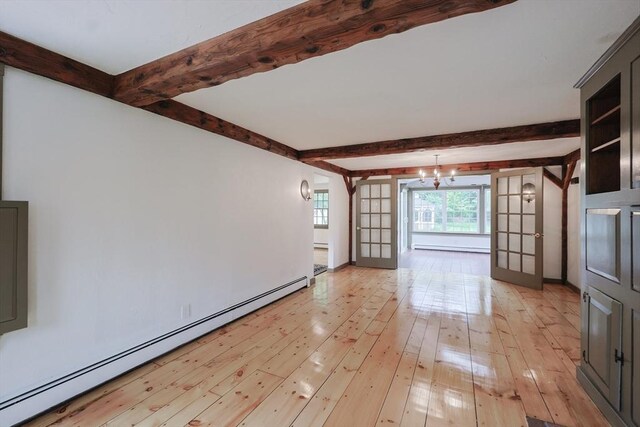 649 S Main St, Raynham, MA 02767 - unfurnished living room featuring a baseboard heating unit, a chandelier, beamed ceiling, light wood finished floors, and baseboards
