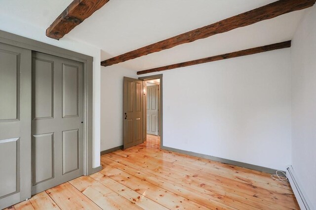 649 S Main St, Raynham, MA 02767 - unfurnished bedroom featuring beam ceiling, a baseboard radiator, light wood finished floors, and baseboards