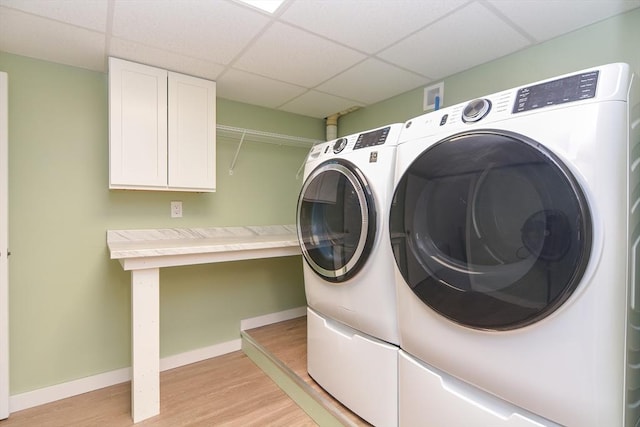 649 S Main St, Raynham, MA 02767 - washroom with washing machine and clothes dryer, light wood-style flooring, cabinet space, and baseboards