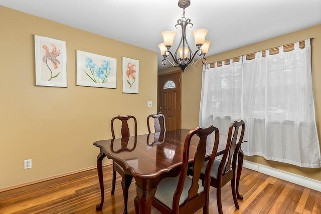 dining room featuring a chandelier and hardwood / wood-style floors