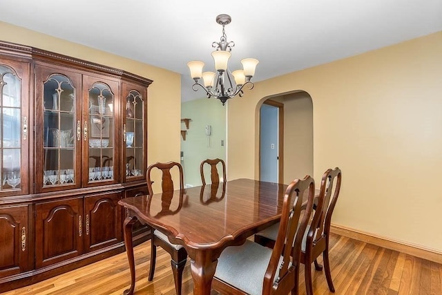 dining room with an inviting chandelier and light hardwood / wood-style flooring