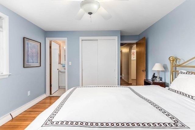 bedroom featuring ceiling fan, a closet, ensuite bathroom, and hardwood / wood-style flooring