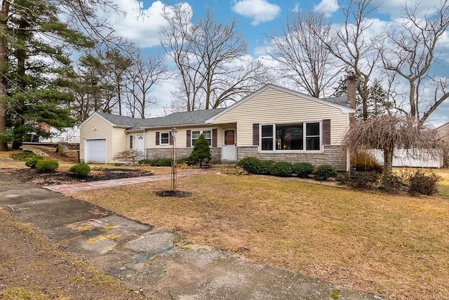 single story home featuring a garage and a front lawn