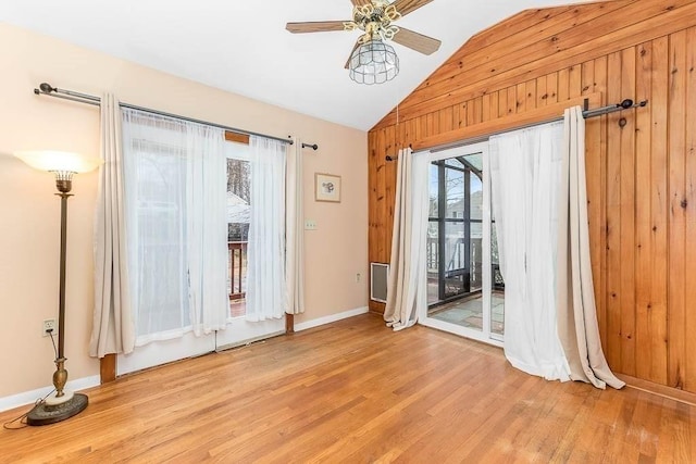 unfurnished room featuring vaulted ceiling, ceiling fan, light hardwood / wood-style flooring, and plenty of natural light