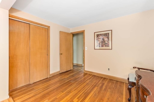 unfurnished bedroom featuring a closet and light hardwood / wood-style floors