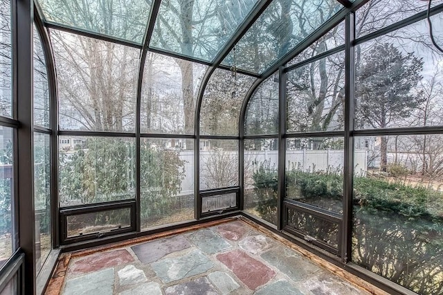 unfurnished sunroom featuring a wealth of natural light