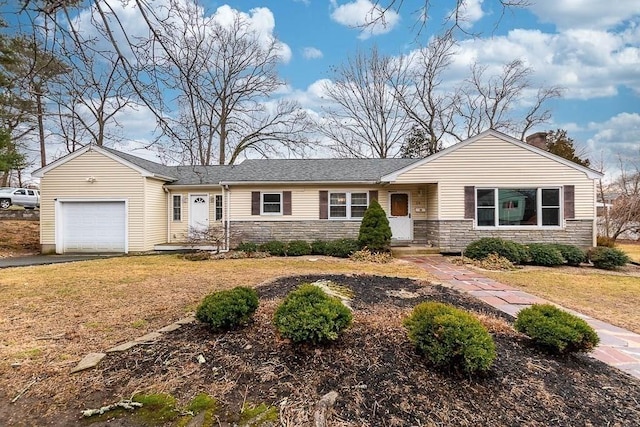 single story home featuring a front lawn and a garage