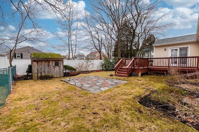 view of yard featuring a deck and a storage shed