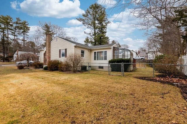 back of house featuring a lawn, central AC unit, and a lanai