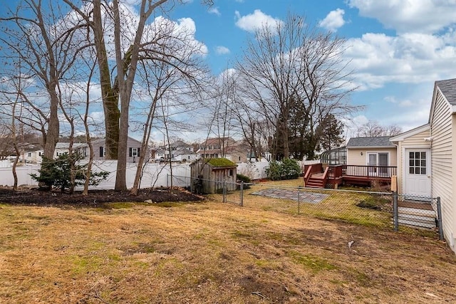 view of yard featuring a wooden deck and a shed