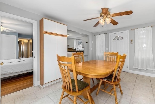 dining room featuring ceiling fan and sink