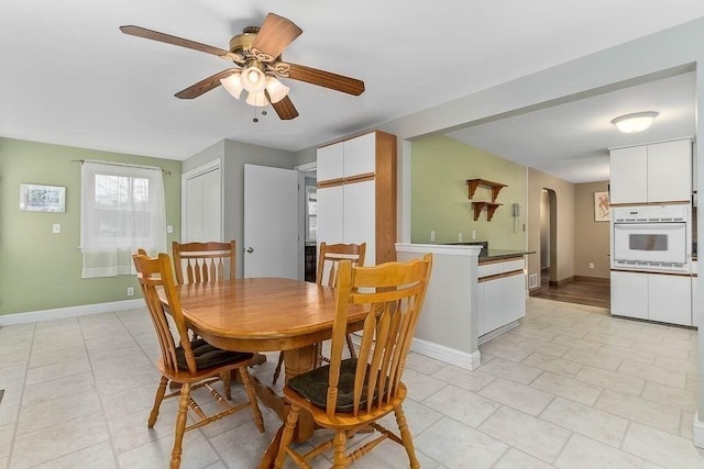 dining space featuring ceiling fan