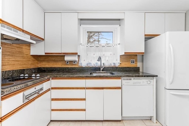 kitchen featuring sink, light tile patterned floors, white appliances, white cabinets, and dark stone counters