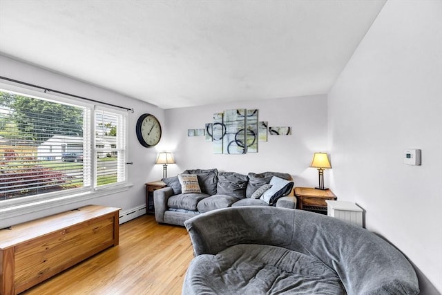 59 Kulig St, Springfield, MA 01104 - living area with a baseboard heating unit and light wood finished floors