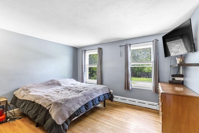 59 Kulig St, Springfield, MA 01104 - bedroom featuring baseboard heating, multiple windows, and light wood-style flooring