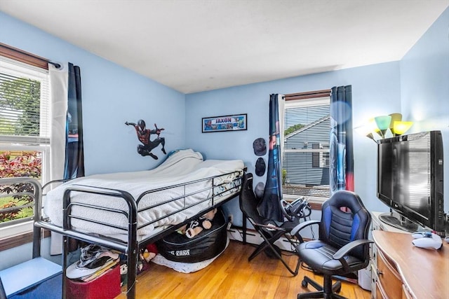 59 Kulig St, Springfield, MA 01104 - bedroom featuring multiple windows, light wood-style floors, and a desk