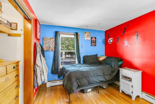 59 Kulig St, Springfield, MA 01104 - bedroom with a baseboard heating unit and wood finished floors