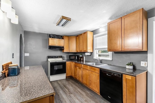 59 Kulig St, Springfield, MA 01104 - kitchen with black appliances, under cabinet range hood, a sink, dark wood-style flooring, and arched walkways