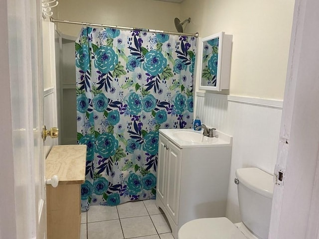 49 Euclid Ave, Springfield, MA 01108 - bathroom with vanity, toilet, tile patterned floors, wainscoting, and a shower with shower curtain