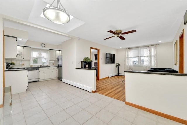 131 Beacon St Unit 4, Chelsea, MA 02150 - kitchen with freestanding refrigerator, dishwashing machine, dark countertops, a baseboard radiator, and a ceiling fan
