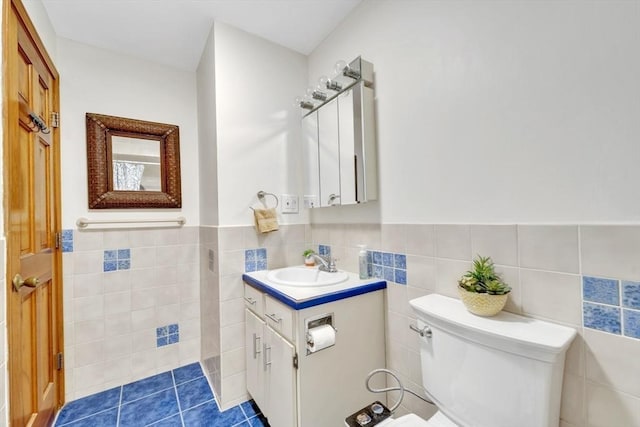 131 Beacon St Unit 4, Chelsea, MA 02150 - bathroom featuring tile walls, vanity, toilet, and a wainscoted wall