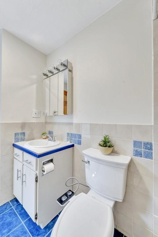 131 Beacon St Unit 4, Chelsea, MA 02150 - bathroom with tile walls, vanity, tile patterned floors, toilet, and a wainscoted wall