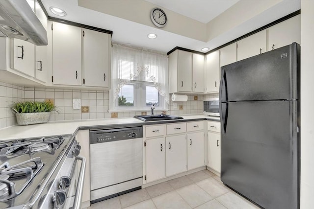 131 Beacon St Unit 4, Chelsea, MA 02150 - kitchen with appliances with stainless steel finishes, a sink, under cabinet range hood, light tile patterned floors, and decorative backsplash