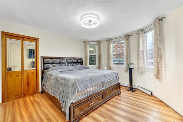 131 Beacon St Unit 4, Chelsea, MA 02150 - bedroom with light wood-style flooring and a baseboard heating unit