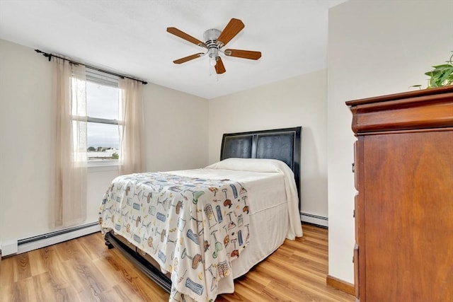 131 Beacon St Unit 4, Chelsea, MA 02150 - bedroom with baseboard heating, light wood-style floors, and ceiling fan