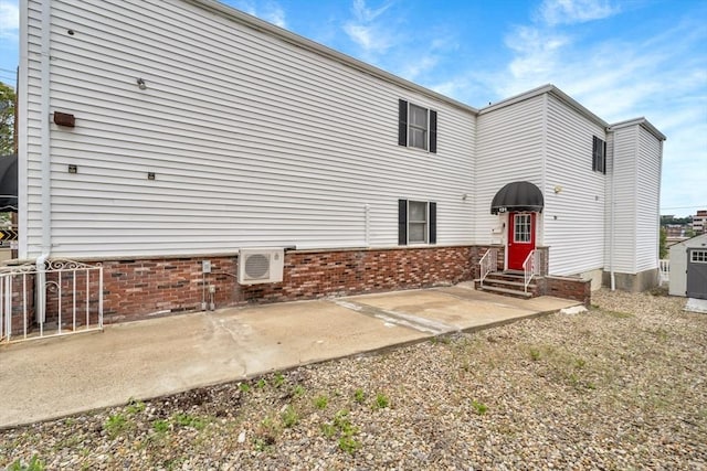 131 Beacon St Unit 4, Chelsea, MA 02150 - back of property featuring entry steps, a cooling unit, and a patio area