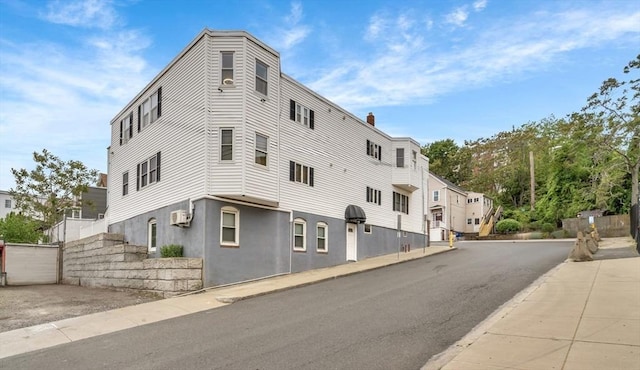 131 Beacon St Unit 4, Chelsea, MA 02150 - view of building exterior featuring an AC wall unit