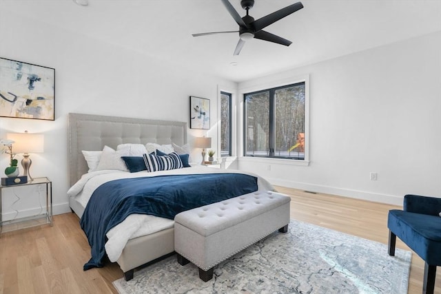 bedroom with wood-type flooring and ceiling fan