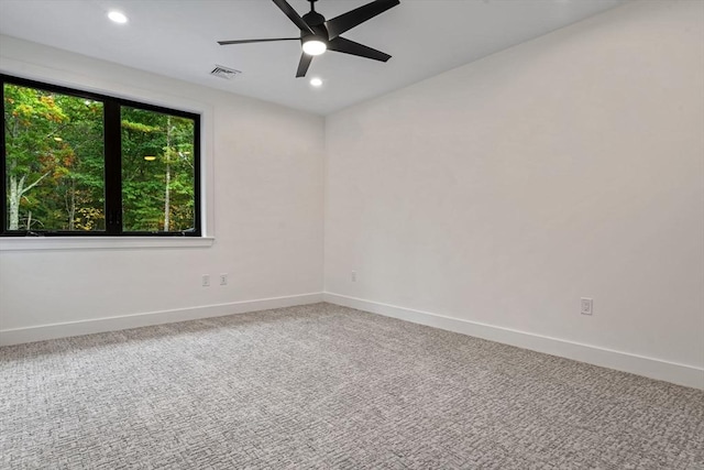 carpeted spare room with ceiling fan