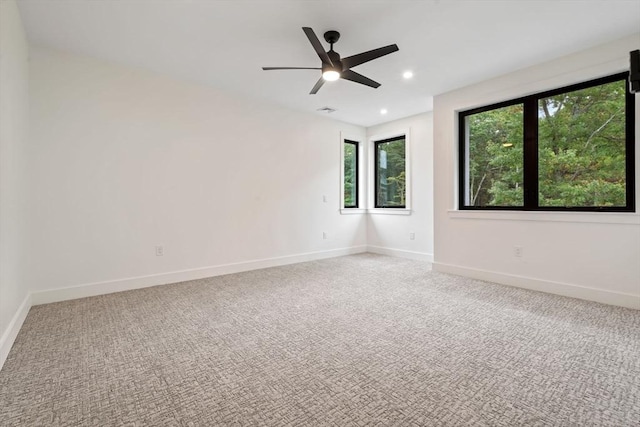 spare room featuring carpet floors and ceiling fan