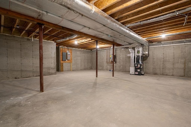 basement with electric panel and heating unit