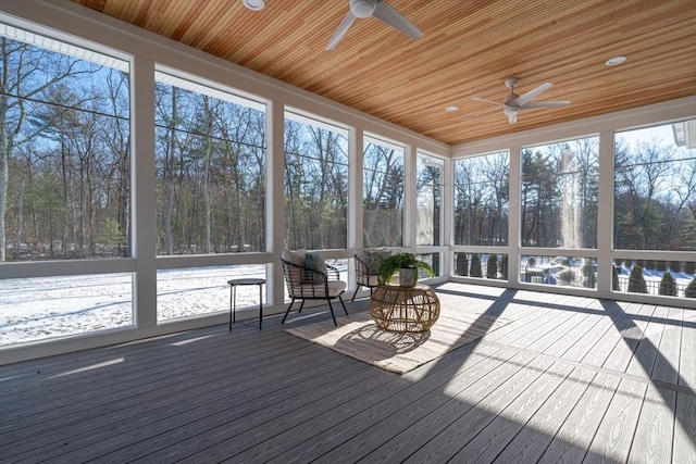 unfurnished sunroom featuring wood ceiling and ceiling fan