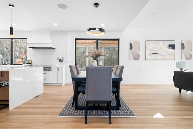 dining area with sink and light wood-type flooring