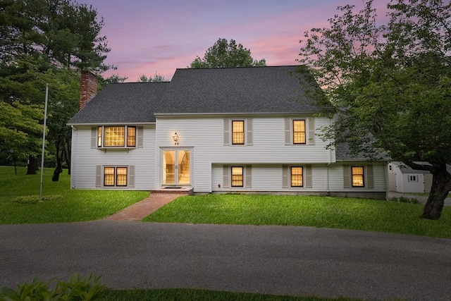 33 Dascomb Rd, Andover, MA 01810 - view of front of home featuring a chimney, french doors, and a front yard