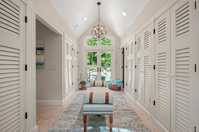 hall featuring french doors, baseboards, a chandelier, and vaulted ceiling