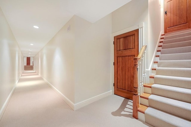 carpeted entrance foyer with recessed lighting, stairs, and baseboards