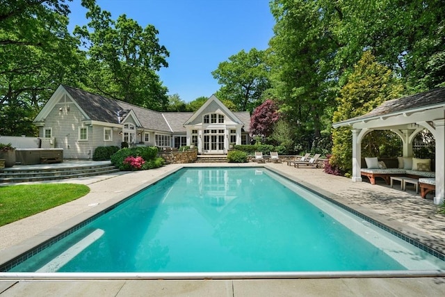 outdoor pool with a gazebo, a patio, outdoor lounge area, and a hot tub