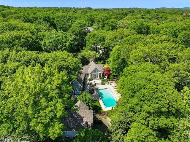 birds eye view of property with a forest view