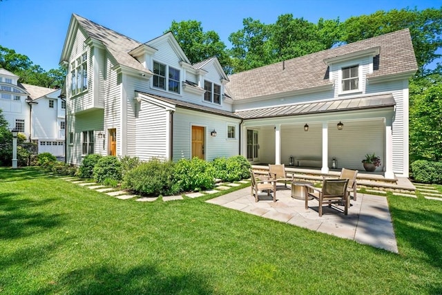 rear view of house with a yard, an outdoor hangout area, a shingled roof, and a patio