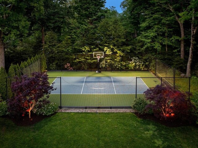 view of tennis court featuring community basketball court, a yard, and fence