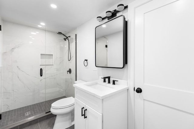full bathroom featuring recessed lighting, toilet, vanity, and a marble finish shower