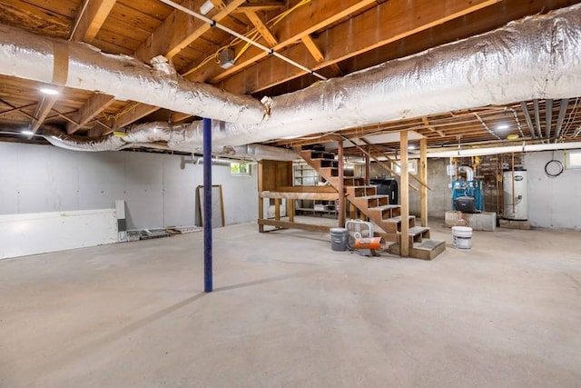 unfinished basement featuring stairway and gas water heater