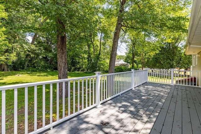 wooden terrace featuring a yard