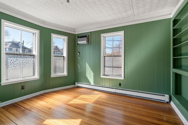 113 Belmont St, Belmont, MA 02478 - empty room with a baseboard radiator, wood-type flooring, plenty of natural light, ornamental molding, and baseboards