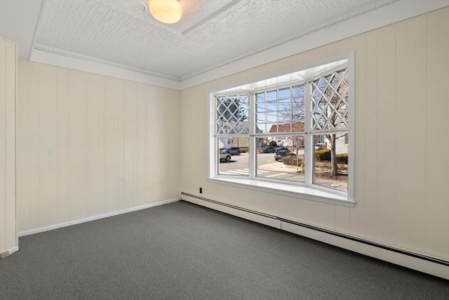 113 Belmont St, Belmont, MA 02478 - carpeted empty room featuring a baseboard radiator, wooden walls, and baseboards